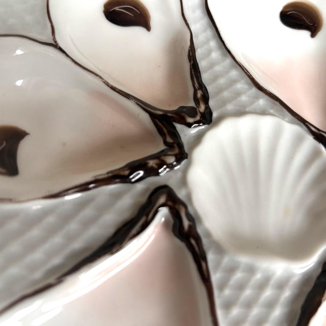 Enhance your collection with this antique French porcelain oyster plate, crafted circa 1880–1910. This beautifully molded...