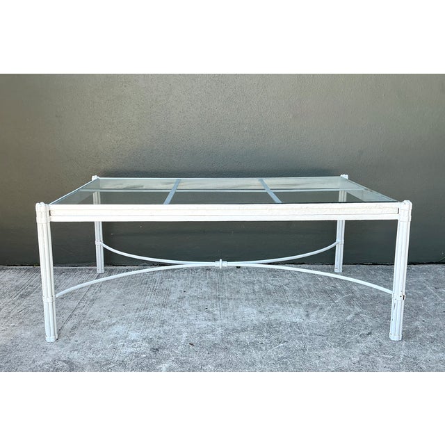 This vintage metal and glass coffee table embodies the refined simplicity of mid-century modern design. Its softly...