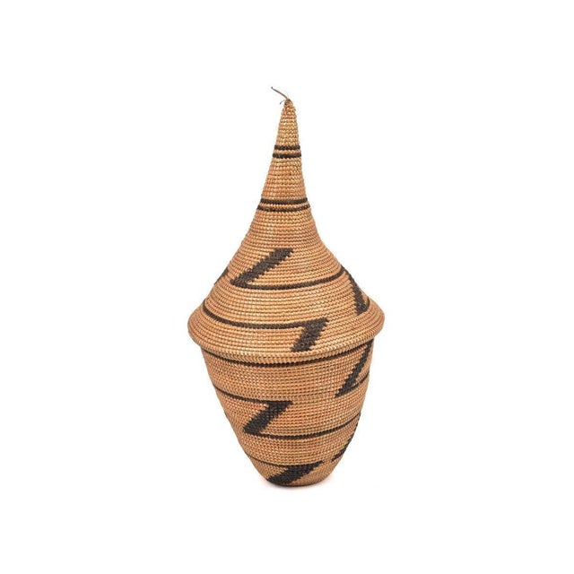 The Tutsi Tight Weave Basket with Lid from Rwanda epitomizes the artistry and tradition of the Tutsi community's weaving...