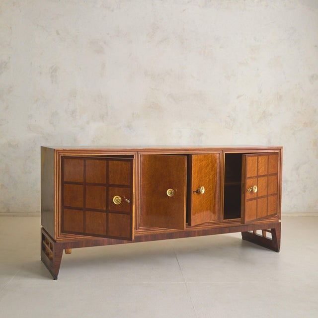 A monumental French rosewood sideboard, dating to the 1940s. Crafted in richly figured rosewood veneers, the façade is...