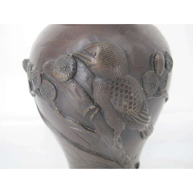 Darling Bronze vase with raised design of blossoms and birds on branches and etched bamboo in background. Measures 7 1/2"...