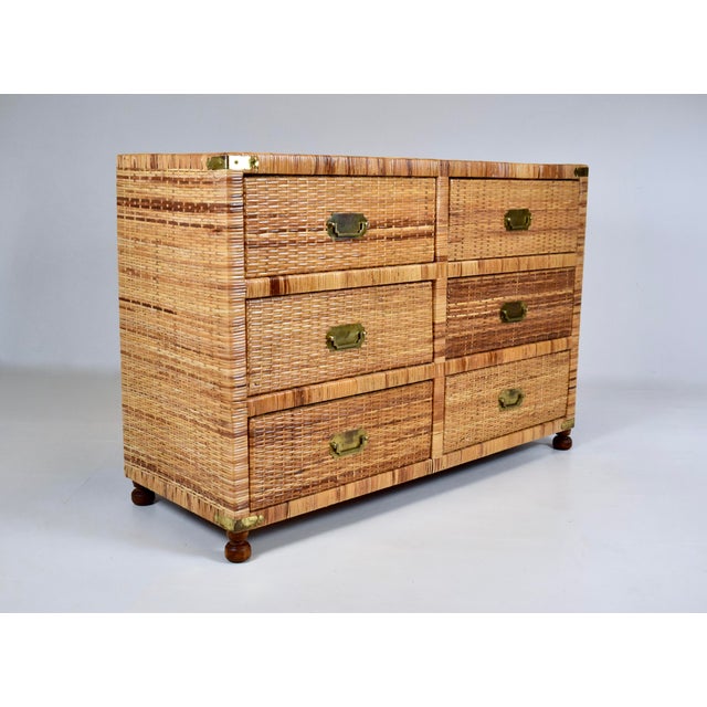 1970's woven rattan footed chest of six drawers in the campaign style with rich honey tones & all original brass hardware....