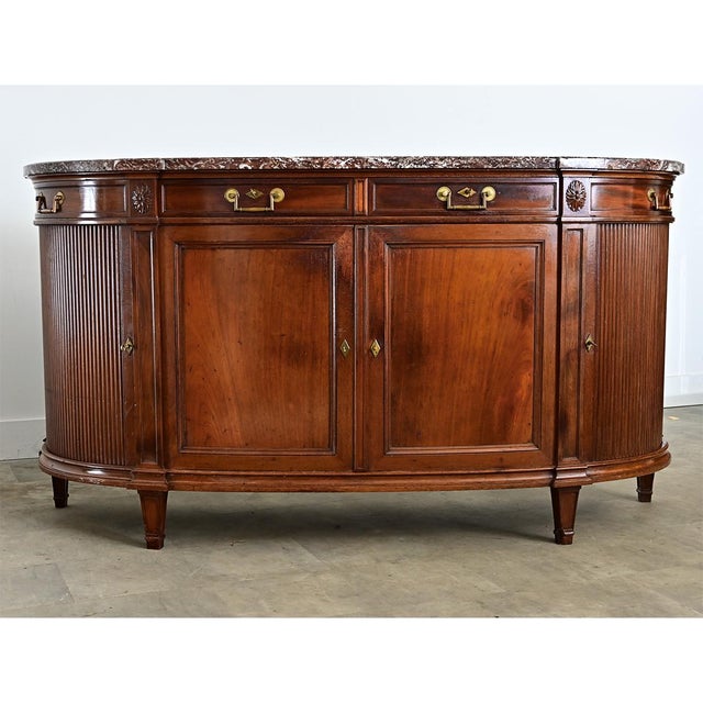 This 19th-century French demilune enfilade is crafted from solid mahogany. The top is an impressive single slab of rance...