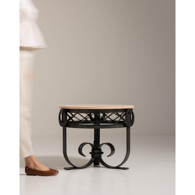 Wrought iron scroll-base table in Warm White Marble. Its warm white marble finish sets off dramatic scrolled iron base,...