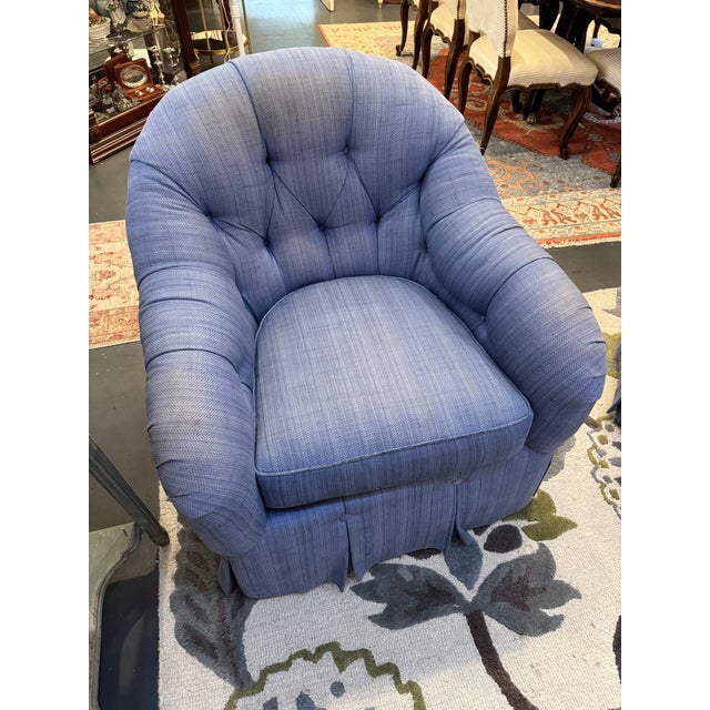 This is a club chair. It also is able to swivel. It is made by Kravet furniture. It has a woven linen fabric in a blue...