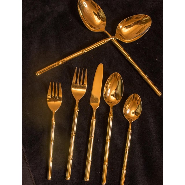 Gold-plated stainless steel flatware by Stanley Roberts, made in Japan. The handles are shaped like bamboo stalks, with...