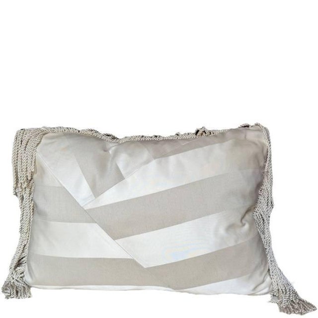 A pillow in our signature style pattern, made with striped silk from Jim Thompson in neutral shades. The pattern is...