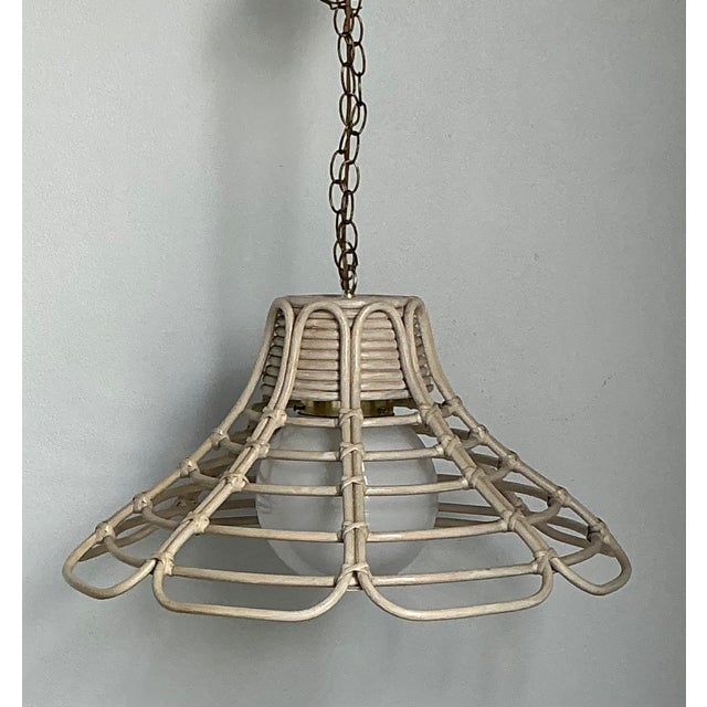 Infuse your interior with the breezy, organic elegance of this vintage washed rattan chandelier. A masterful example of...