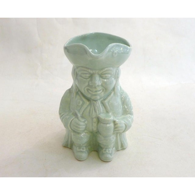 Small English "Toby Jug" Pitcher Anthropomorphic pitcher depicting a seated figure holding a beer mug in one hand and a...