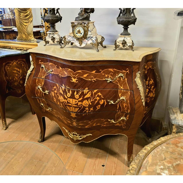 Make a statement with this magnificent French bombe commode, showcasing exceptional floral marquetry, graceful serpentine...