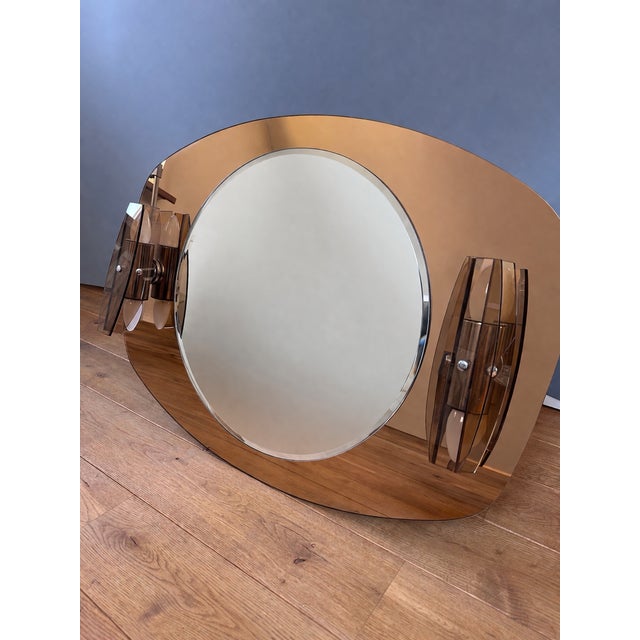 A striking Sonnenberg wall mirror, dating from the 1970s. This Mid-Century Modern piece features strong Space Age...