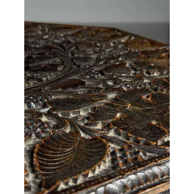 Anglo-Indian hand-carved side table. Late 19th century. Fine hand carving featuring leaves and bunches of grapes, among...