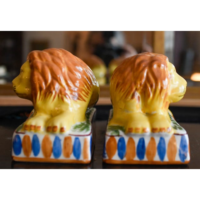 Very charming original pair of antique Staffordshire recumbent lions on striped rectangular plinths. These rare antique...