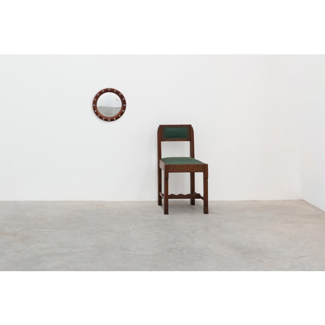 A distinctive Belgian round wall mirror manufactured by Deknudt during the 1960s. The mirror is framed by a warm-toned...