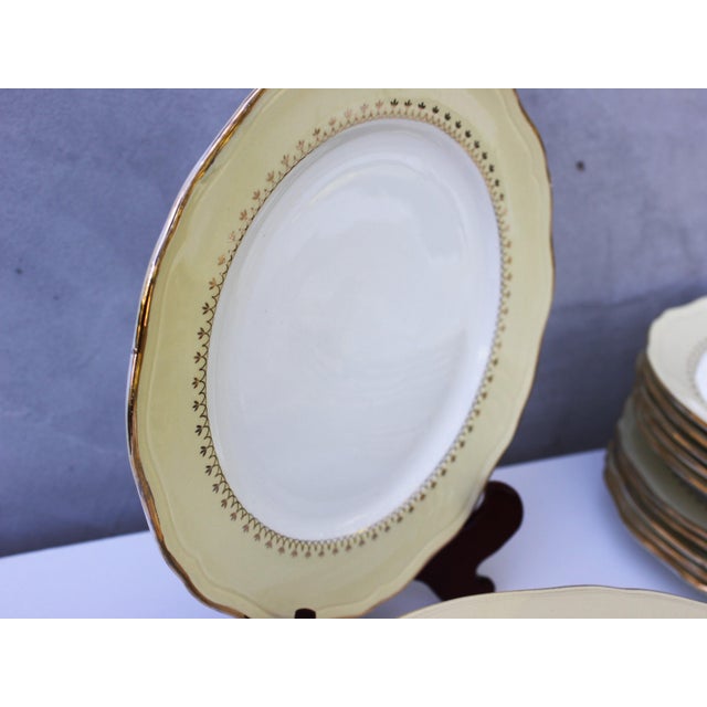 A refined vintage porcelain dining service produced by L'Amandinoise, France, featuring the sought-after 9727 pattern....