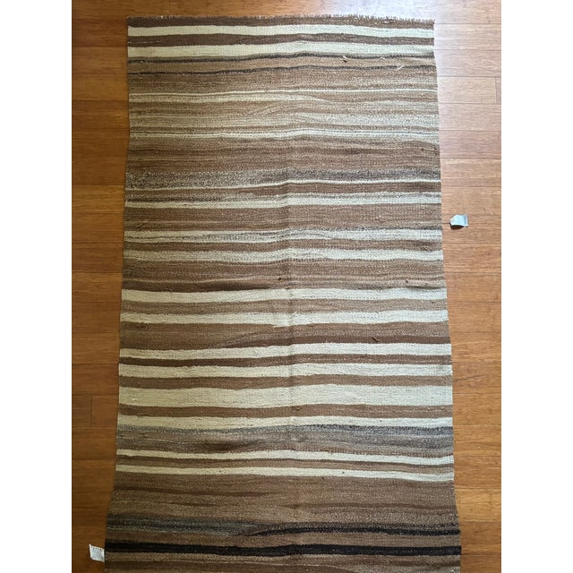 A beautiful celebration of material and simplicity, this vintage striped kilim showcases the understated elegance of...