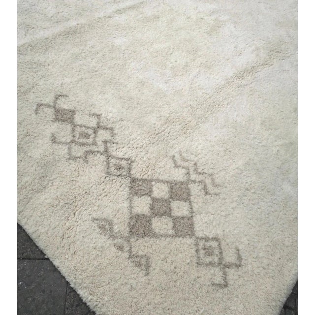 Mid Century Beni Ourain rug from Morocco with a cream white pile and sparse abstract decoration. Very good condition,...
