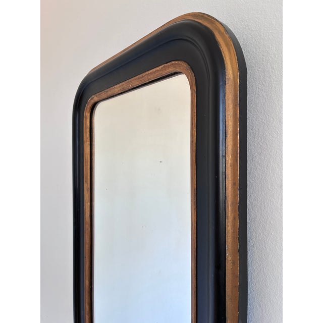 An elegant small antique French Louis Philippe mirror dating from the late 19th century. This full-length mirror features...