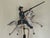 A charming vintage folk art sculpture of a soldier charging on a galloping horse, captured in a kinetic balancing...
