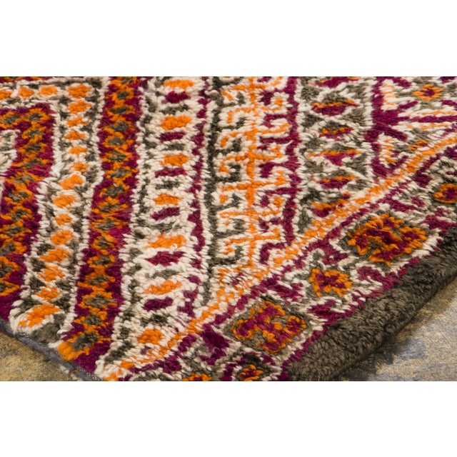 Hand-knotted in wool and originating circa 1950-1959, this 7x10 vintage Moroccan rug joins Rug & Kilim’s Moroccan...