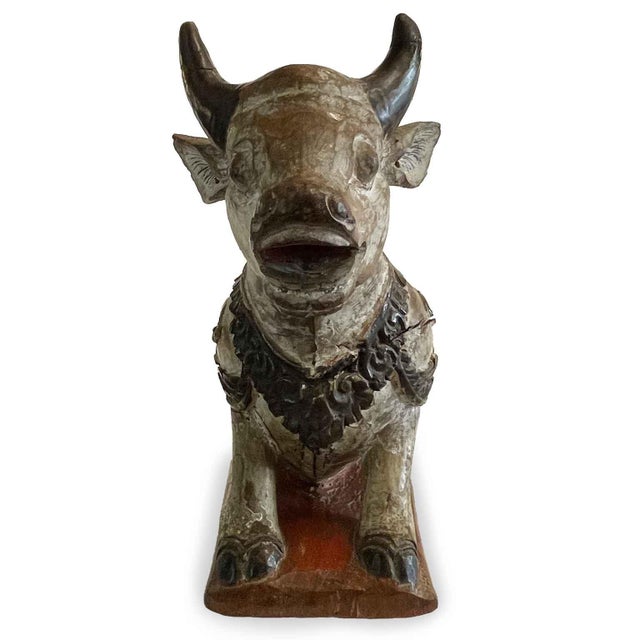 A visibly antique, hand-carved, wooden Nandi cow from India. This wooden sculpture features a wonderful patina due to its...