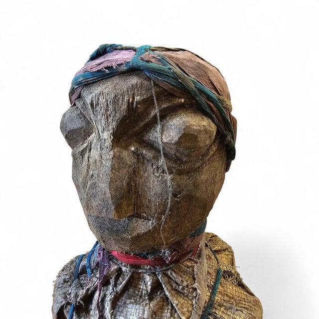 This African piece / 1970s / is made from natural materials such as wood / cloth /twine, and raffia or other fibers, which...