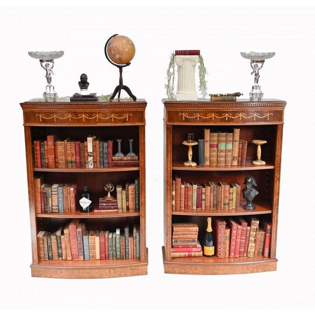 Wonderful pair of walnut open front bookcases in the Sheraton manner Hand crafted from walnut with satinwood inlay, these...
