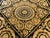 Hand knotted black and gold rug in wool pile on cotton foundation.