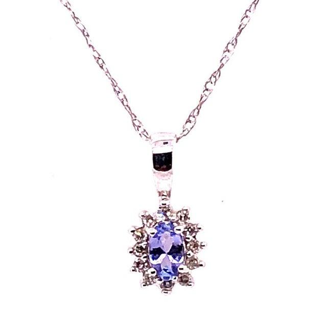 14 Karat White Gold 16 Inch Necklace with Diamonds and Oval Tanzanite Pendant. 2.33 grams total weight. Pendant and Chain...