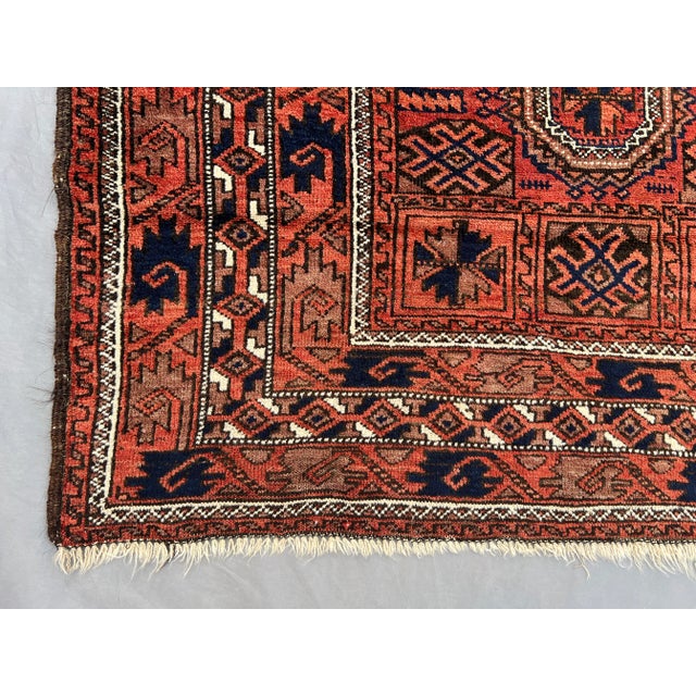 Ruby Red Antique Afghan Baluchi Rug With Geometric Tribal Medallion Design in Terracotta and Navy Rug For Sale - Image 8 of 11