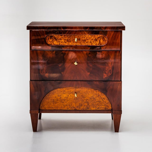 Classic three-drawer Biedermeier chest from Northern Germany, made around 1830. The design is characterized by clean...
