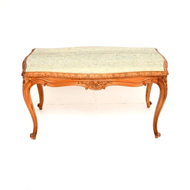 A beautiful antique French carved walnut marble top coffee table, dating from around the 1930’s. It has a lovely design,...