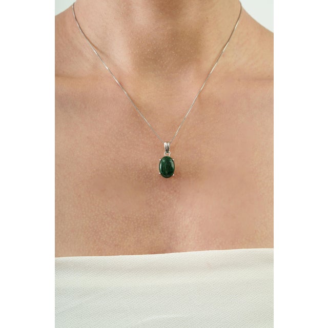 The Modernist 10.74 Ct Malachite Cabochon Solitaire Pendant features a striking 10.74-carat malachite gemstone in an...
