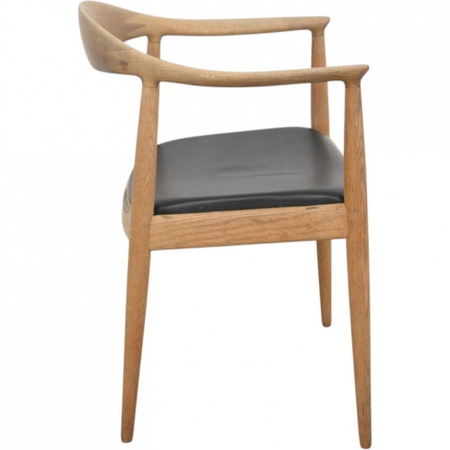 Hans Wegner The Chair, model JH503, with a frame of oak and a seat upholstered in black leather. The chair is from the...