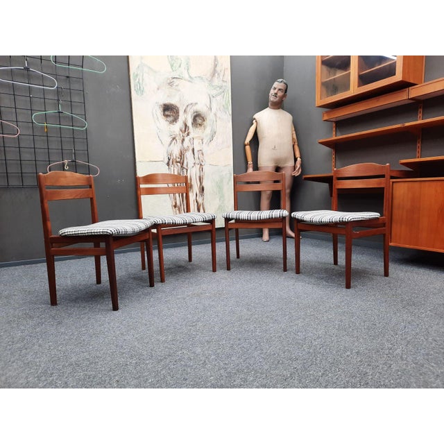 This set of four teak dining chairs is a real joy. The seats have been reupholstered with a matching and durable fabric....