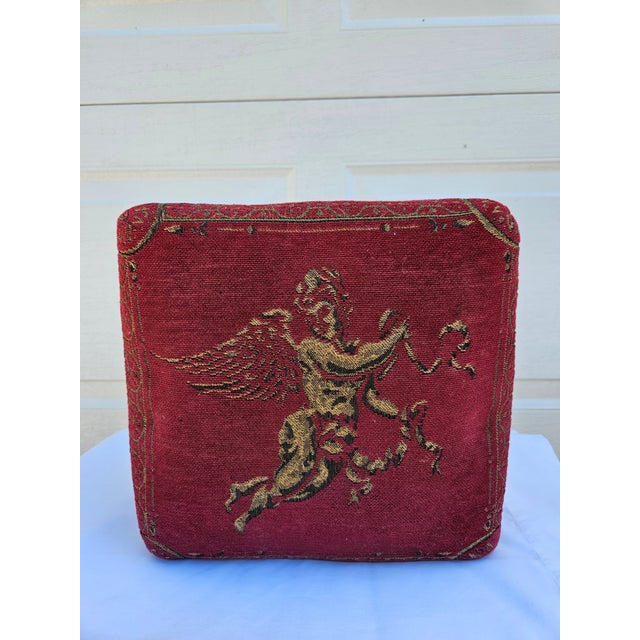 This reproduction Victorian style footstool has the look of an antique French tapestry featuring a golden cherub. The base...