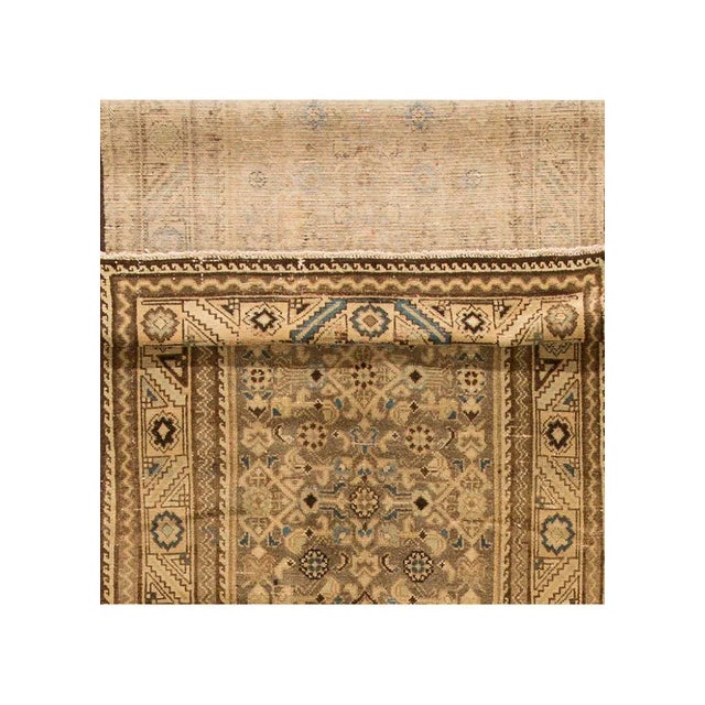 Beautiful vintage Persian Malayer hand-knotted wool runner with a tan field. This rug has a beige and brown accent in an...