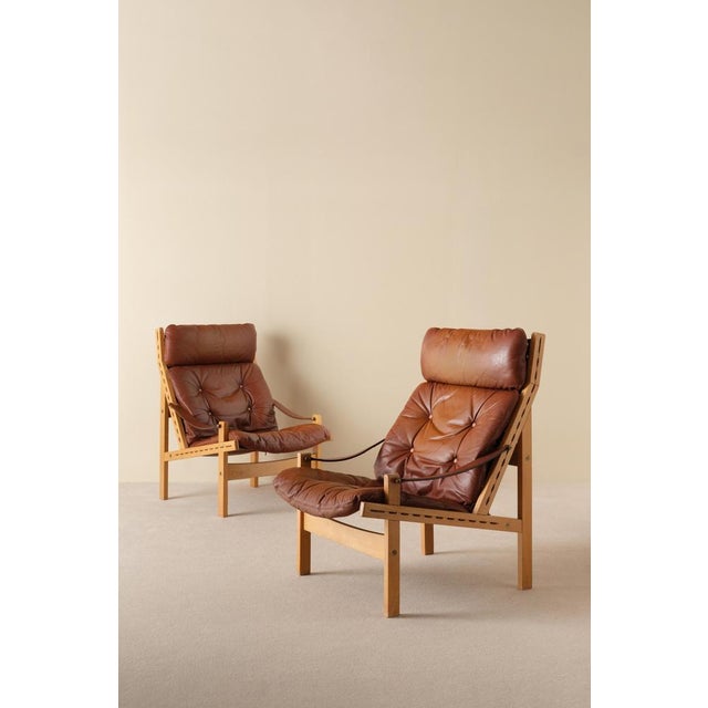Great pair of safari chairs model Hunter designed by Torbjørn Afdal, produced by Bruksbo. Original brown leather cushions....