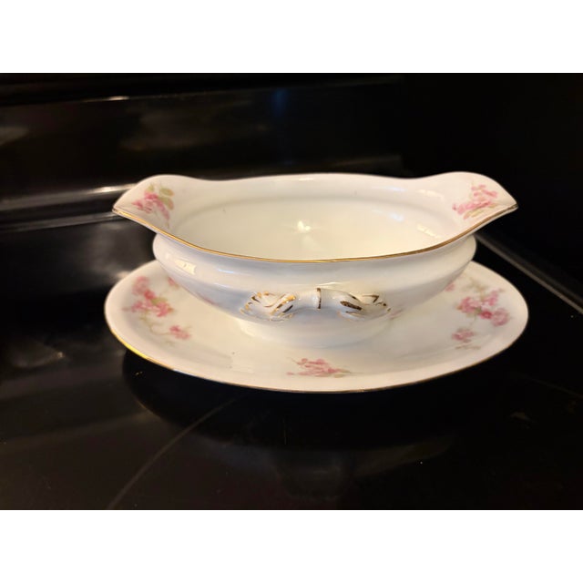 An exquisite antique porcelain gravy boat with an attached presentation underplate, produced by Royal Schwarzburg in...