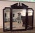 Thomasville Mahogany Collection Triple Dresser with Brass pulls. Triple beveled hinged mirror with pediment. Mirror...