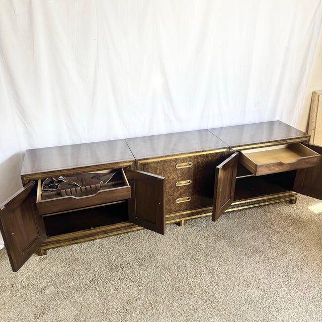 striking example of Hollywood Regency glamour, this Mastercraft burlwood and brass credenza embodies the bold...