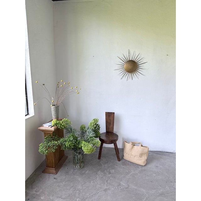 Vintage 1950s wall sconce in a sunburst design, crafted from gilded metal. We love its unique shape. The large, wavy...