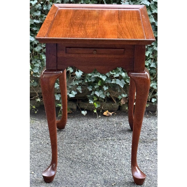 Elegant solid cherry tea table by Pennsylvania House. Features elegant cabriole legs with pad feet, pullout slides and a...
