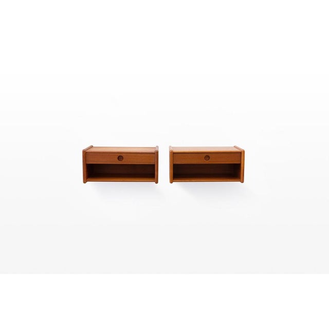 Set of two wall-mounted night cabinets in teak. Designed and manufactured in Denmark in the 1960s by Vildbjerg...