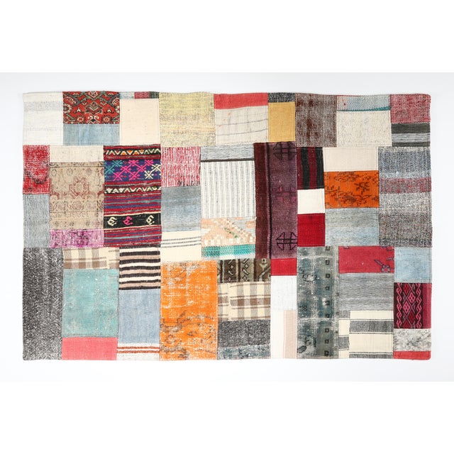 This striking patchwork kilim is a one of a kind composition crafted from handwoven vintage fragments of tribal Turkish...