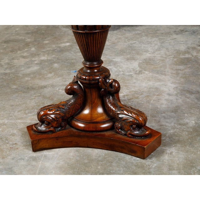 An English walnut side table from the 19th century, with hexagonal top, grape vine carved apron and dolphin motifs....