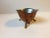 This is a small organically shaped nut or candy bowl fashioned out of a bent copper plate that has been lined with pewter....