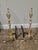 A handsome pair of traditional solid brass andirons featuring elegant turned shafts and timeless urn-form finials. These...