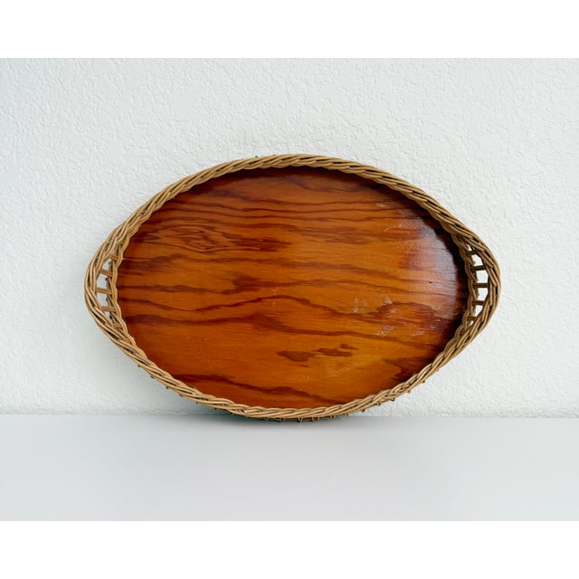 French style, early 20th-century woven wicker oval tray in a mid-brown color. Features braided wicker rim, integrated...