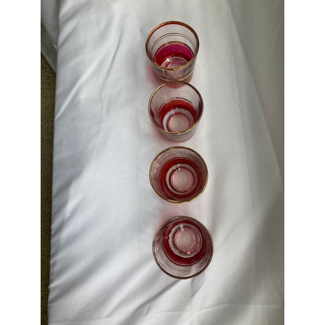 Vintage Cranberry Flashed and Gold-Banded Juice Tumblers featuring flashed bottom with gold banding. THIS IS A SET OF 4.
